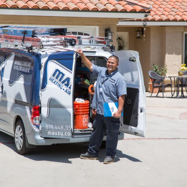 Mauzy technician posing next to company van at a customer's house