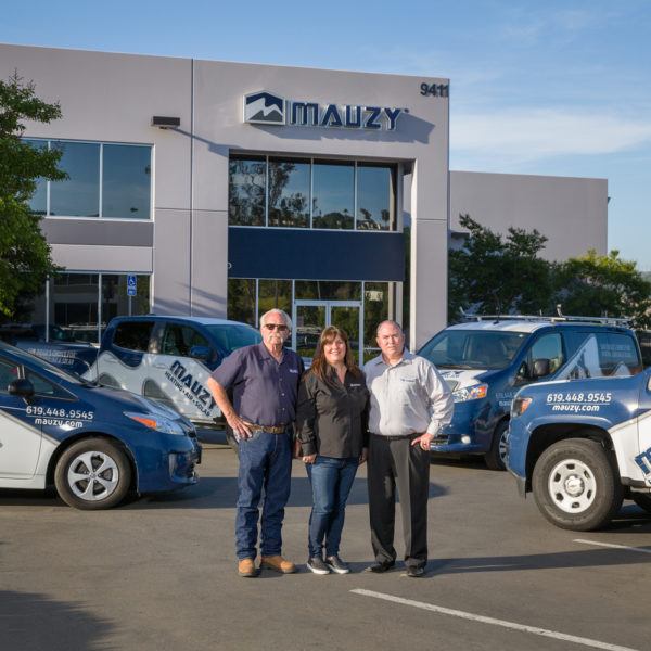 Gary Mauzy, Jennifer Mauzy and Matt Mauzy posing in front of Mauzy offices