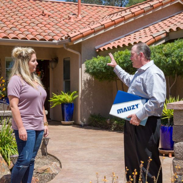 Mauzy comfort advisor and homeowner standing in the front yard discussing a project