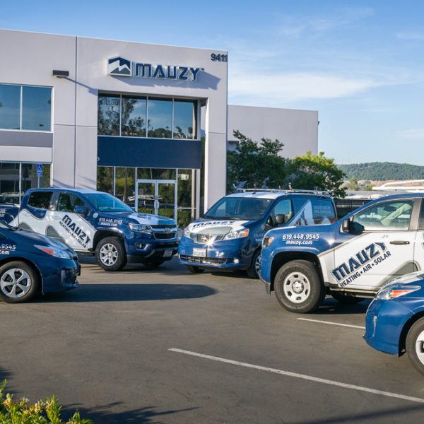 fleet of Mauzy vehicles parked outside the Mauzy offices