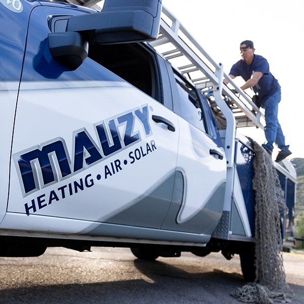 Mauzy installer climbing on truck