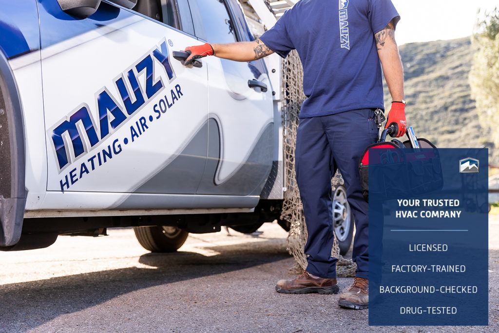 mauzy technician with tools standing next to truck