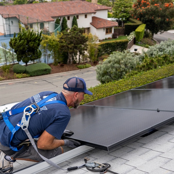 mauzy solar technician installing solar on a roof