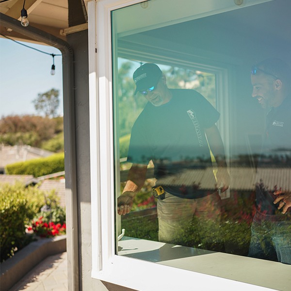 mauzy window installers inspecting a window